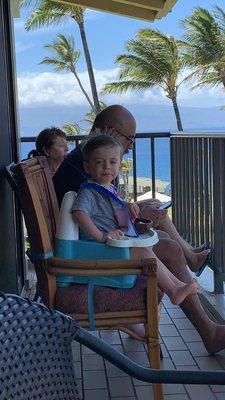 Having a blast eating his lunch in his booster seat on our balcony! It really came in handy!