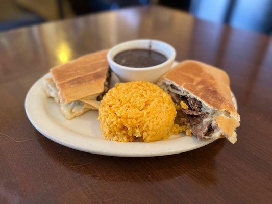 Steak sandwich with yellow rice & black beans