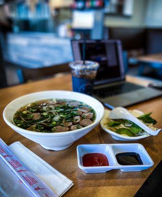 Beef and chicken broth pho with thin noodles and meatballs.