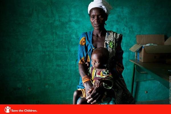 Awa waits with her son for medication to treat malaria. We are working around the world to treat kids with this terrible disease