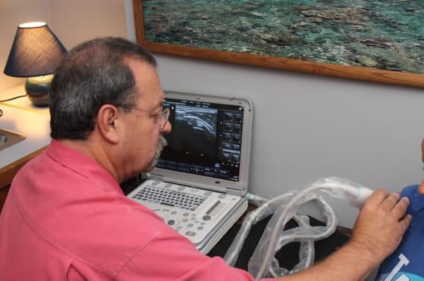 Dr. Tim Ursich using diagnostic ultrasound to better evaluate an injury.