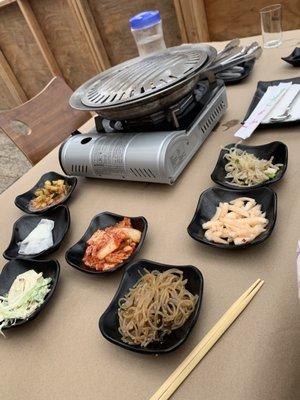 Banchan spread and outdoor set up.