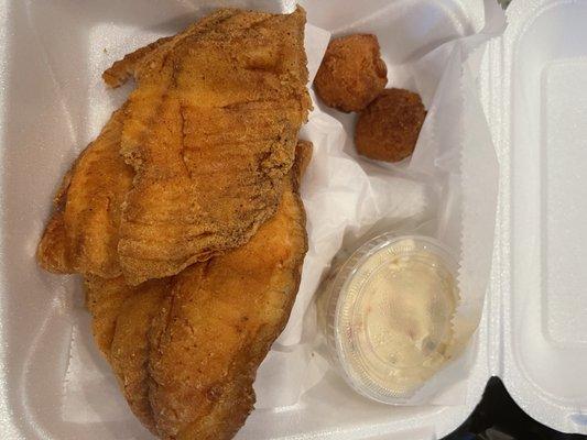 Tilapia dinner with potato salad as the side