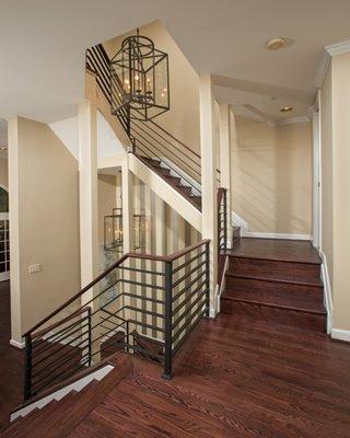 The dated wooden railings throughout this town home were updated with custom metal railings and the hardwood throughout was refinished.