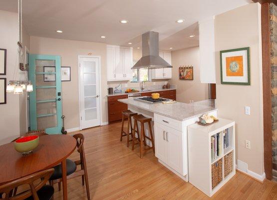 This two tone kitchen features custom sapele cabinets with continuous grain, white upper cabinets and new stainless steel appliances.