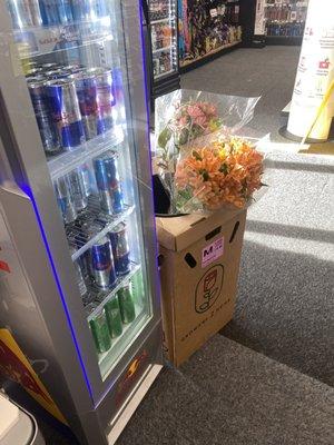 flowers next to sodas