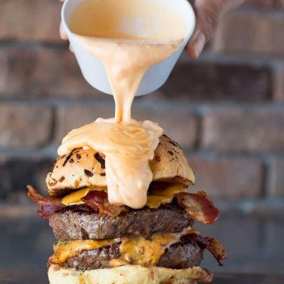 The Big Hoss
Two 6oz Patty's, 4 slices of American cheese, 4 slices of bacon, on a toasted onion roll all covered in cheese sauce!