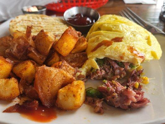 G omelet with big chunks of juicy pulled pork, potatoes and english muffin with strawberry jam.