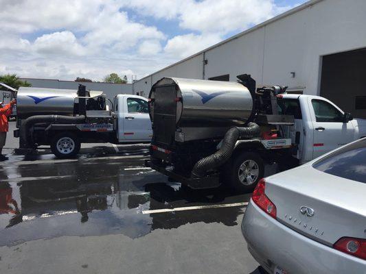 This is a photo of my team members cleaning our sweeper trucks.