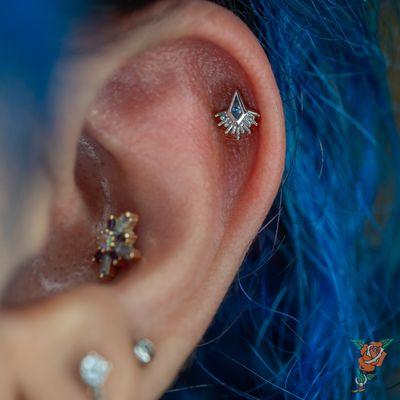 Helix piercing with a white gold and tanzanite borderline kite from Bvla.