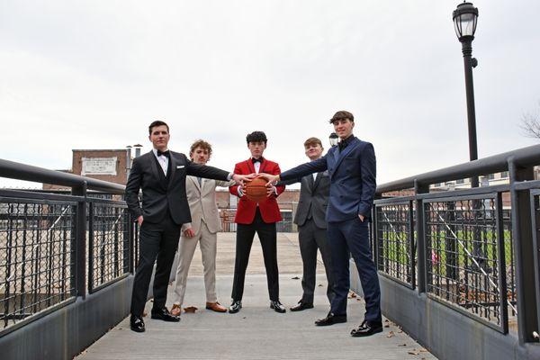 A group of young people wearing prom formalwear