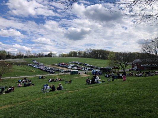 A view of dog park, parking, food truck and bldgs.