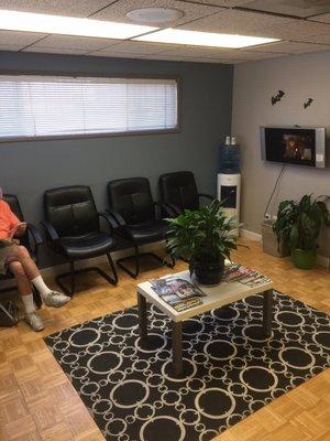 Cozy waiting area with TV and cold water.