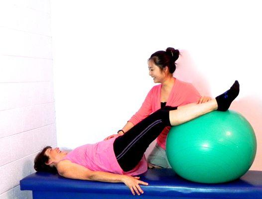 Angela works with patients to improve core strength.