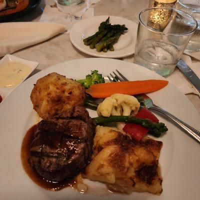 Filet mignon, crabcake, and potatoes &veggies plus asparagus.