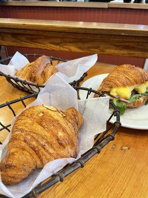 Almond croissant, regular croissant, and egg croissant breakfast sandwich