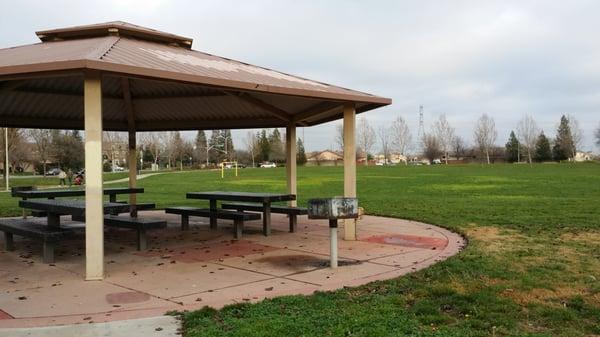 Sitting area with BBQ grill in front of kids play area