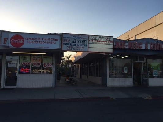 Look for the sign above a walkway. You won't see the store from the parking lot.