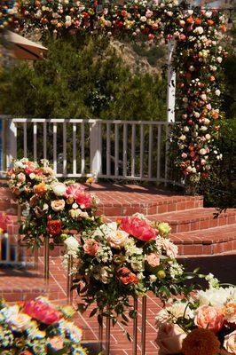 Ceremony arch and aisle flowers