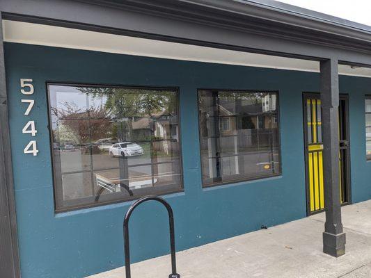 Anatomy Acupuncture is located at 5744 E Burnside Street - a teal colored single story building with yellow doors.