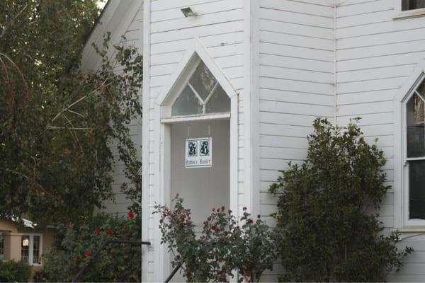 South facing door to the clapboard church. The building is used for music recitals, theater performances & events.