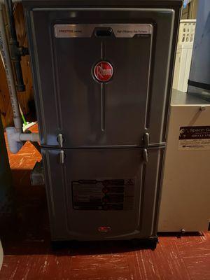 Exterior view of a Rheem furnace during a tune-up in Janesville, WI.