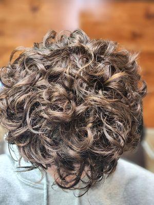 Subtle highlights to promote a more visual curl while avoiding bleach and maintenance