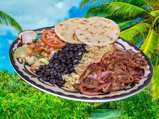 Bistek encebollado/ sauteed steak with red onions. Served with rice, beans and salad. two hand made tortillas.