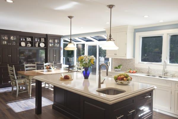 Dark  stained cherry island, carrara countertops; white Rutt Custom Cabinetry Cabinets;