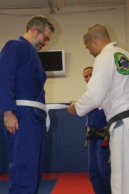 Thomas receiving a degree on his White Belt - December 2015