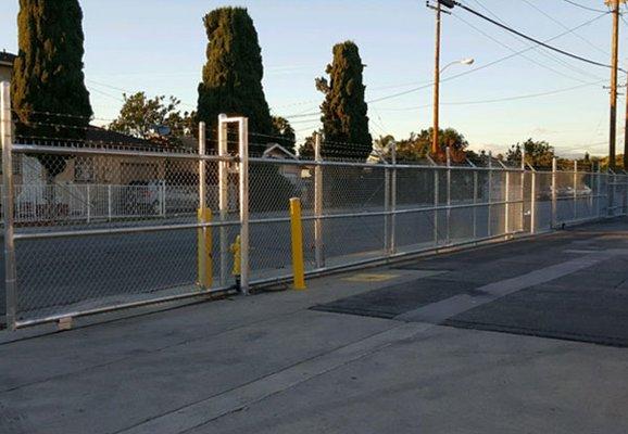 Lavin Fence installed this 52' chain-link rolling gate in Santa Ana, CA, which allows for select vehicle access at this parking lot.