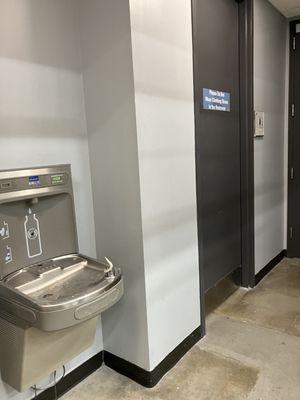 Water fountain is located outside in the hallway