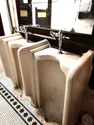 Vintage but clean men's room.