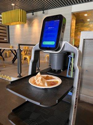 Robot bringing out the Curry Chicken Roti Plate