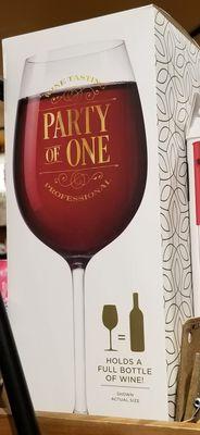 A wine glass that holds a full bottle of wine