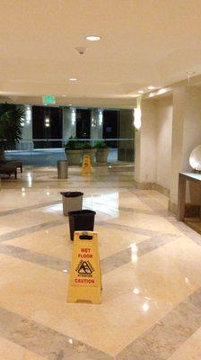 Lobby corridor to elevator: Water dripping out through cieling lighting.