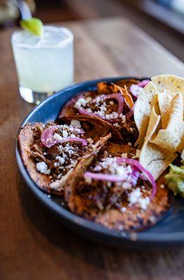 Goat birria tacos from the 'We Go South' menu. Perfectly paired with a margarita!