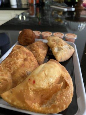 A tray of empanadas and Bola de Yuca Queso