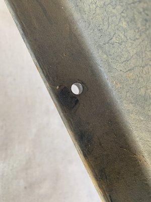 Hole drilled in the frame where the wire to nowhere was attached