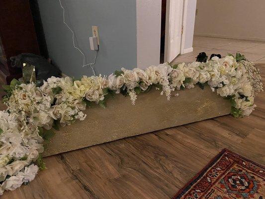 Flowers from Dollar Tree cut and trimmed and put on a styrofoam back board for the back drop of wedding ceremony.