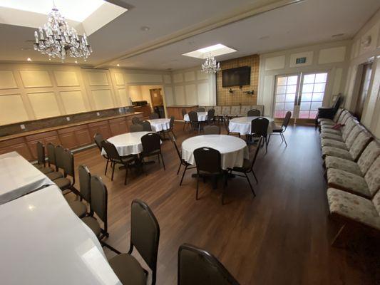 Henrietta Reception Room, showing flat screen TV and seating.