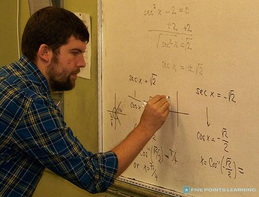 Math tutor, Mr. Eli, solving a math problem.