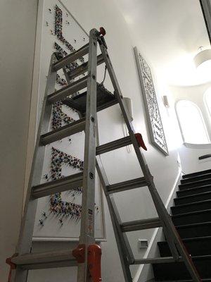 Art Installation of two 9'Art Fran over a staircase