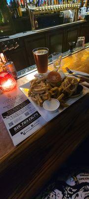 Konami burger on potato bun with bacon,  L&T, house  sauce, & grilled onions with  blue cheese  fries  and  brown  ale