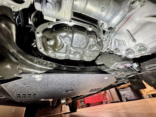 Underside of truck all shiny and black spots from oil when driving