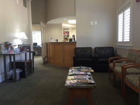 Waiting room. Comfy chairs. Refrigerator with water too.