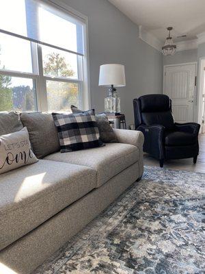 Recliner and part of sectional in livingroom.