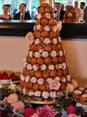 Croquembouche French wedding cake decorated with fresh flowers from "Susi's Flowers" in Aptos.