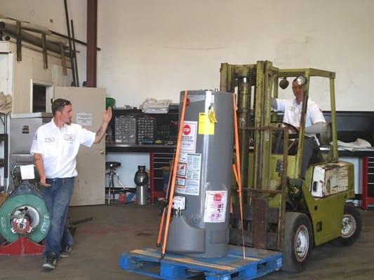 Jeremy and Anthony loading a water heater.