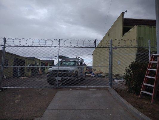 Commercial gate with bar wire and razorwire